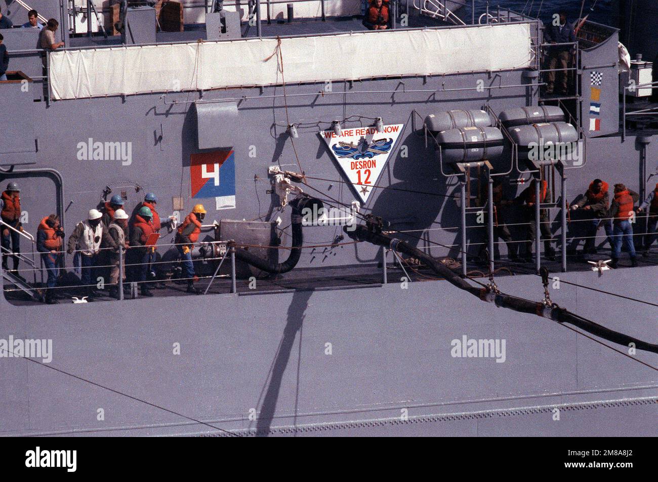 Crewmen aboard the frigate uss elmer montgomery ff 1082 stand by to