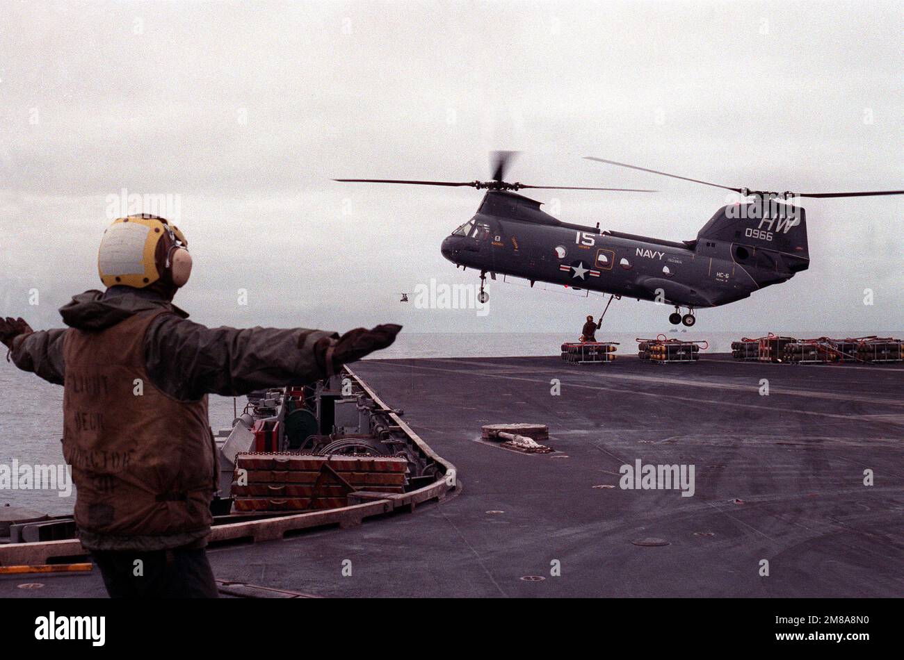 A plane director guides a helicopter combat support squadron 6 hc 6