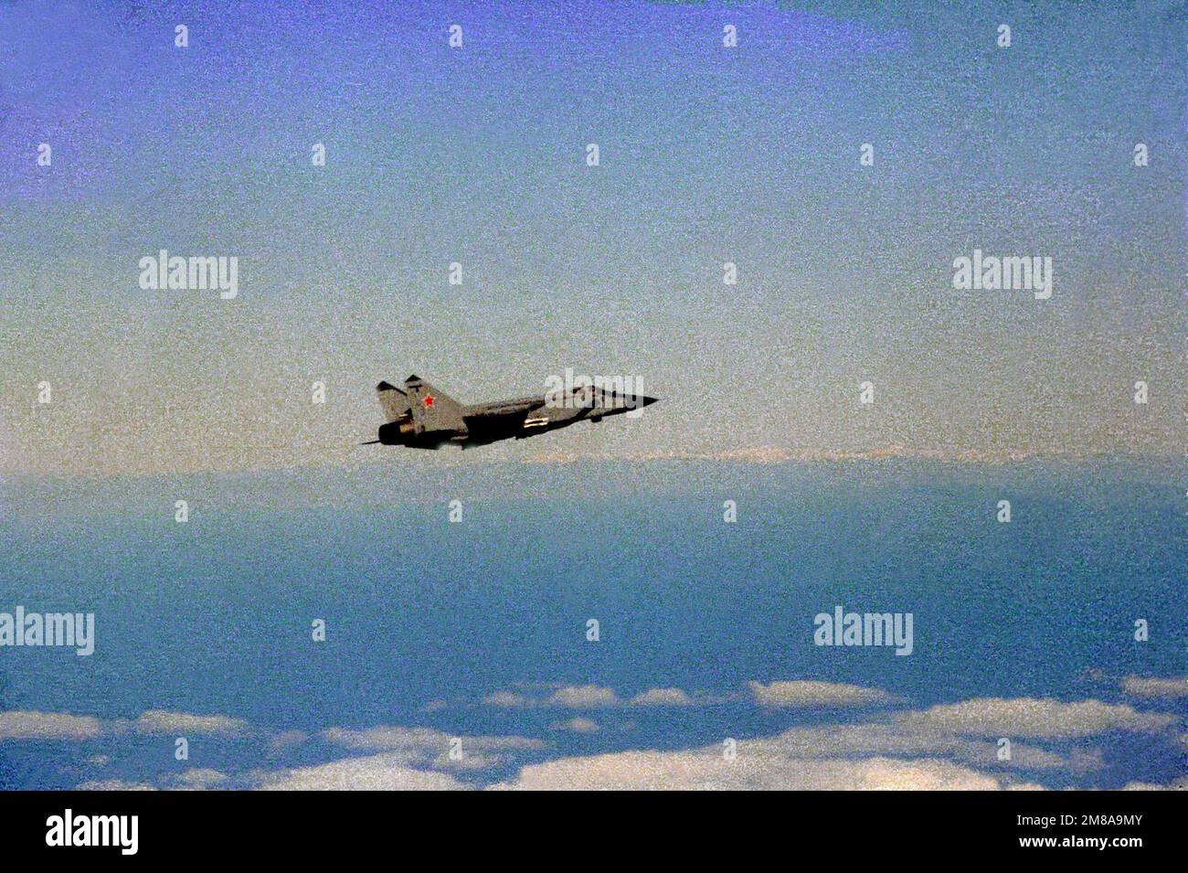 An air-to-air right side view of a Soviet MiG-31 Foxhound aircraft. Country: Unknown Stock Photo