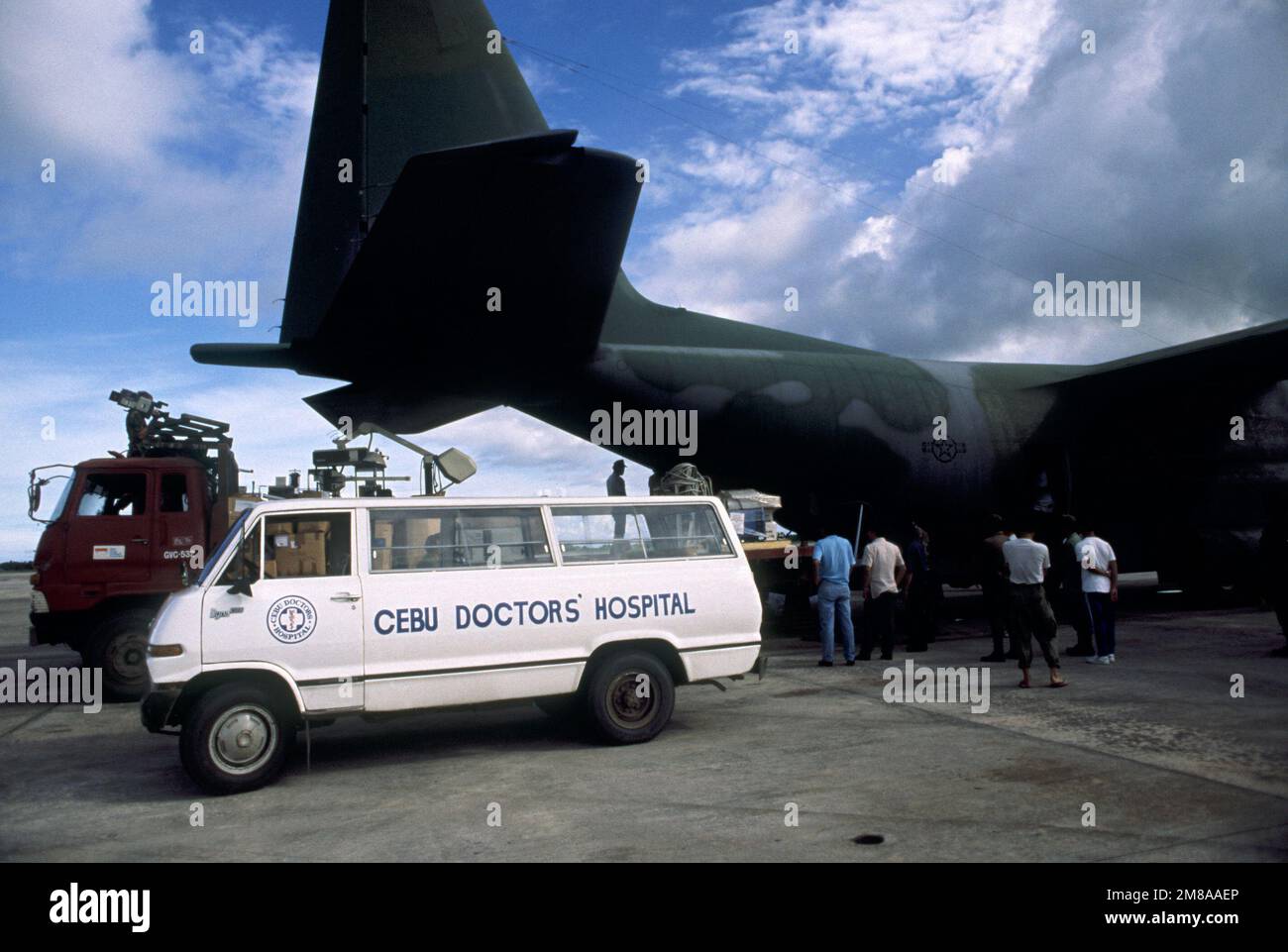 Medical supplies are unloaded from a C130 Hercules aircraft into a