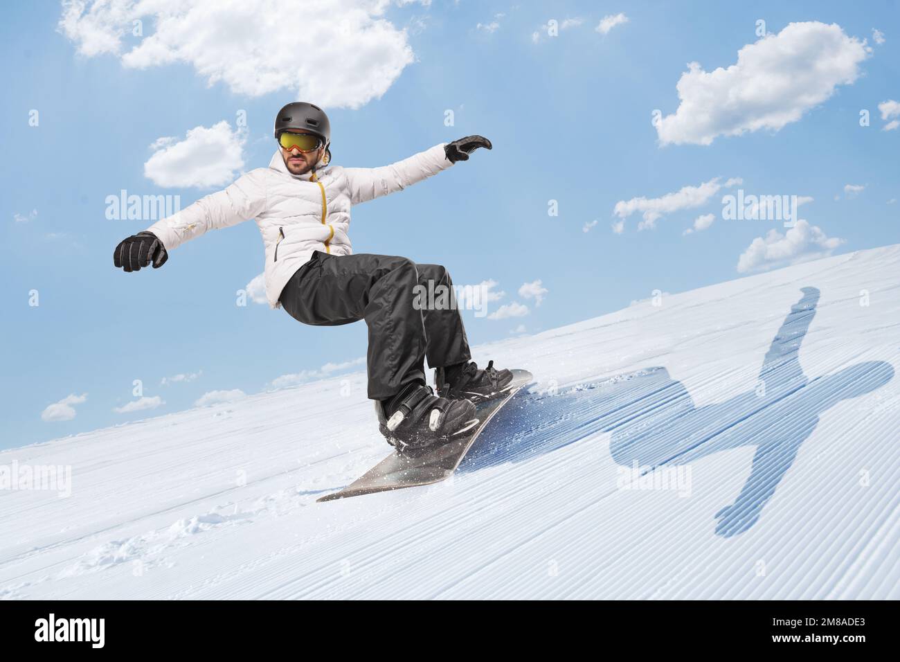 Man riding a snowboard downhill on a snowy hill Stock Photo Alamy