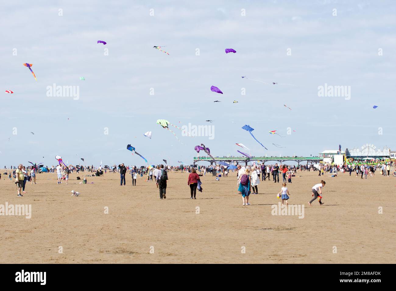 People enjoy the St Annes Kite Festival as the sun shines on the beach