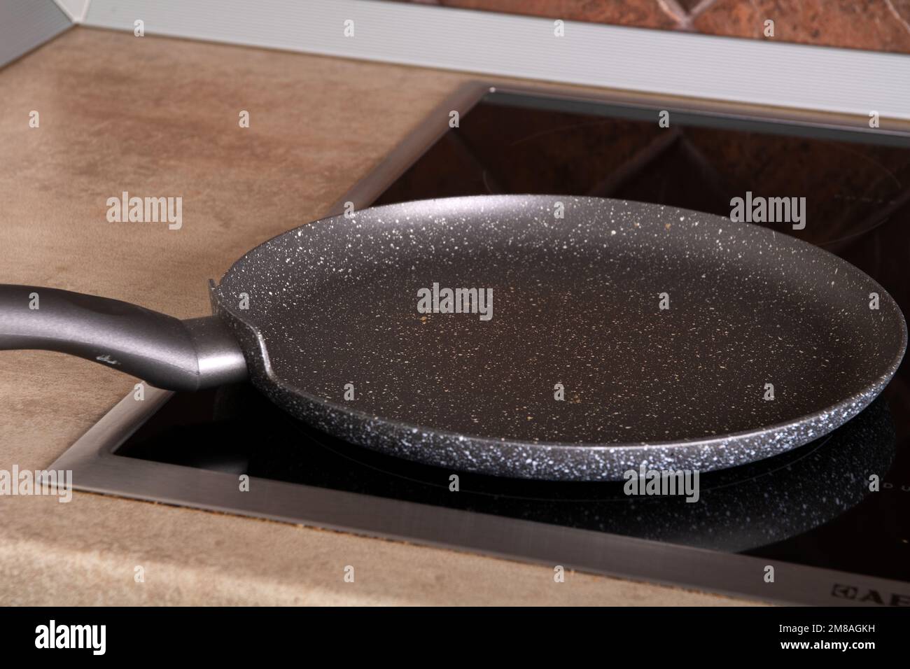 photo of an empty pan for thin pancakes standing on the stove Stock