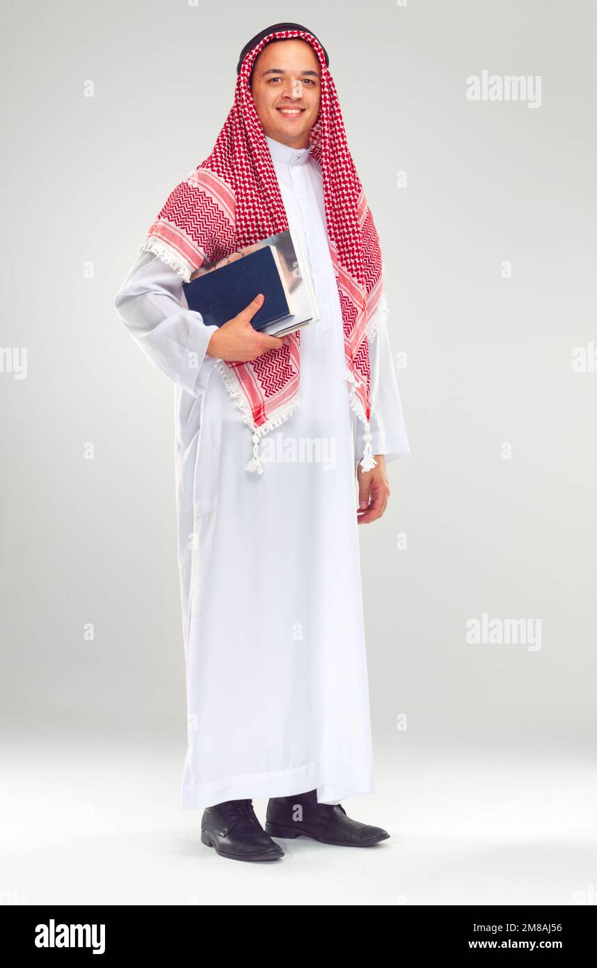 Portrait, Islamic man and books for education, knowledge and guy isolated on white studio background. Muslim, male and student with journals, smile Stock Photo