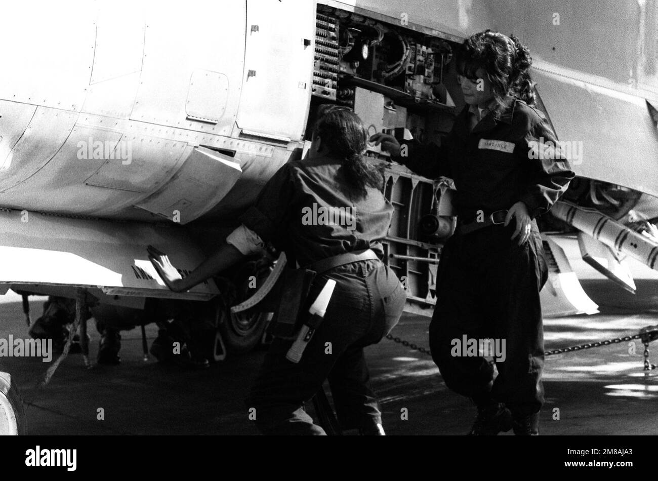 AIRMAN Ora Howard, plane captain, left, and AIRMAN Grisselle Martinez ...