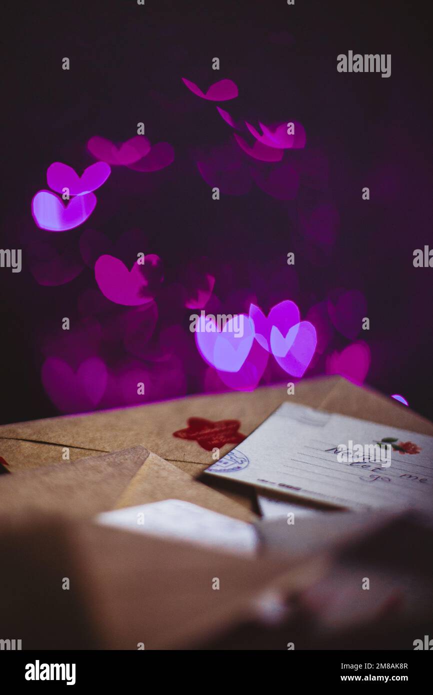 Valentines day letters, cards, glowing violet hearts in the dark Stock Photo