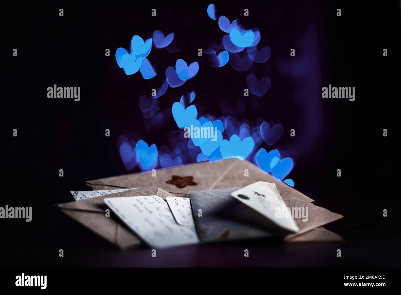 Valentines day letters, cards, blue glowing hearts in the dark Stock Photo