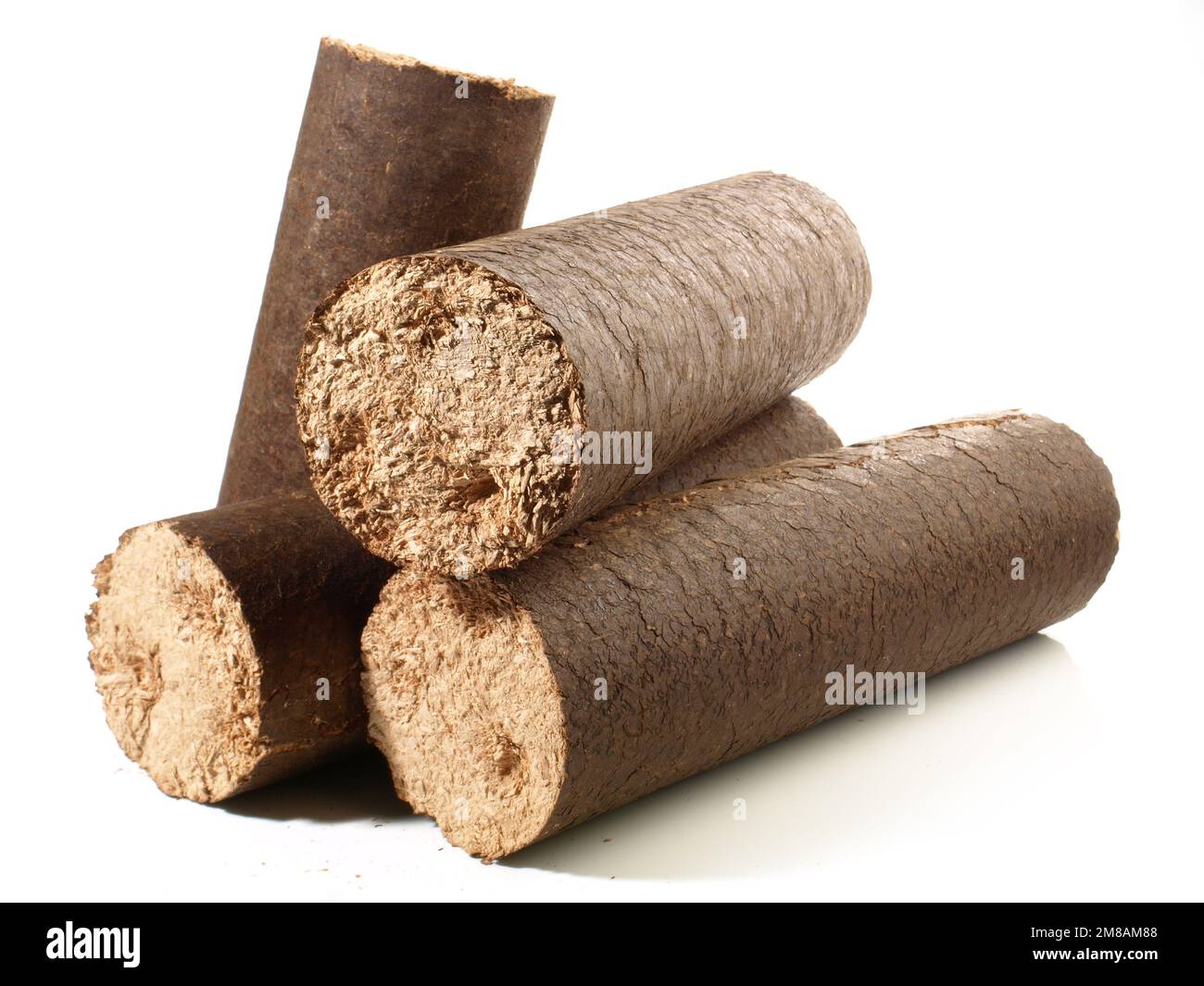 Round Hardwood Sawdust Briquettes - Compressed Biomass Wood Fire Logs isolated on white Background Stock Photo