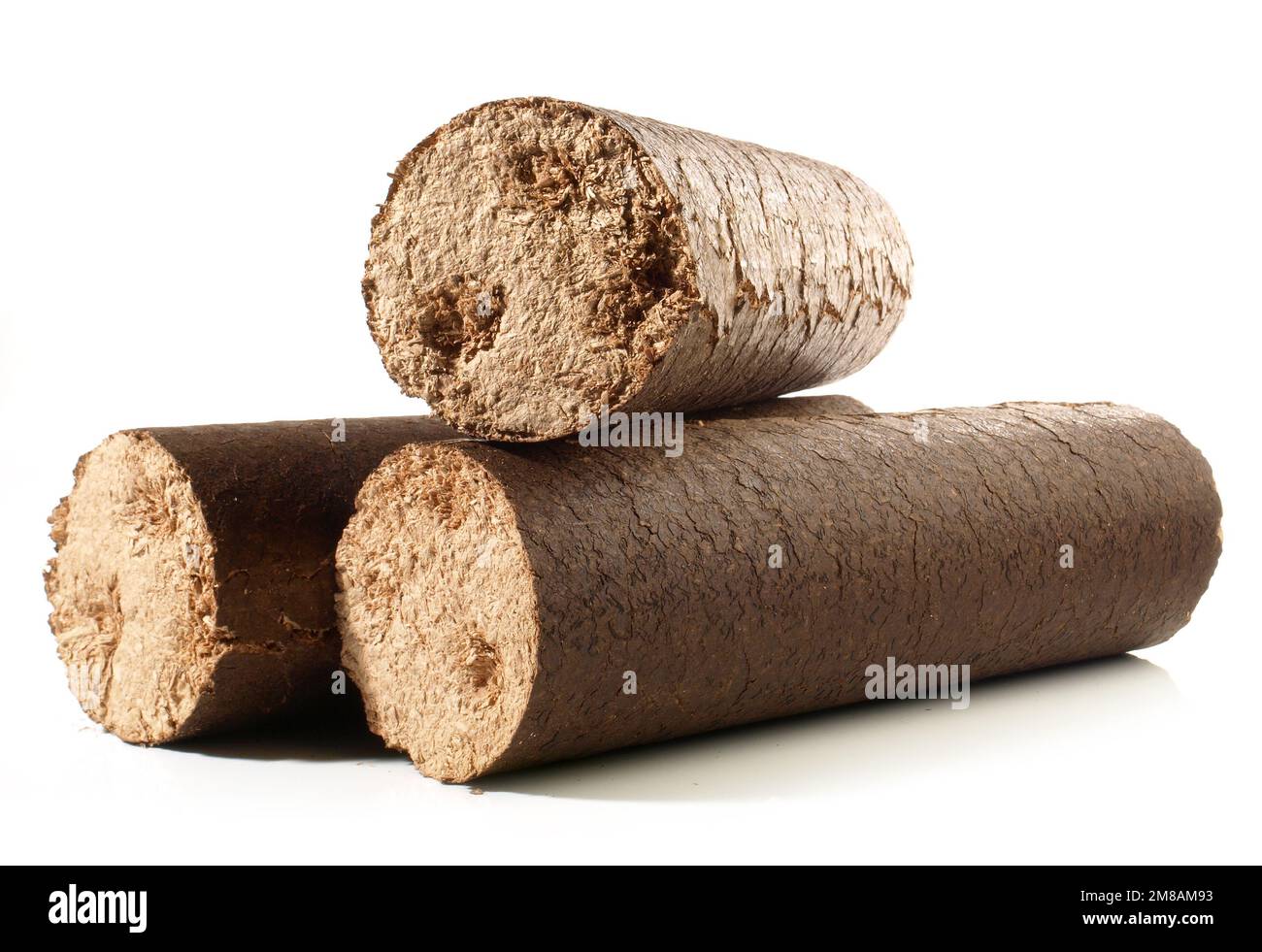 Round Hardwood Sawdust Briquettes - Compressed Biomass Wood Fire Logs isolated on white Background Stock Photo