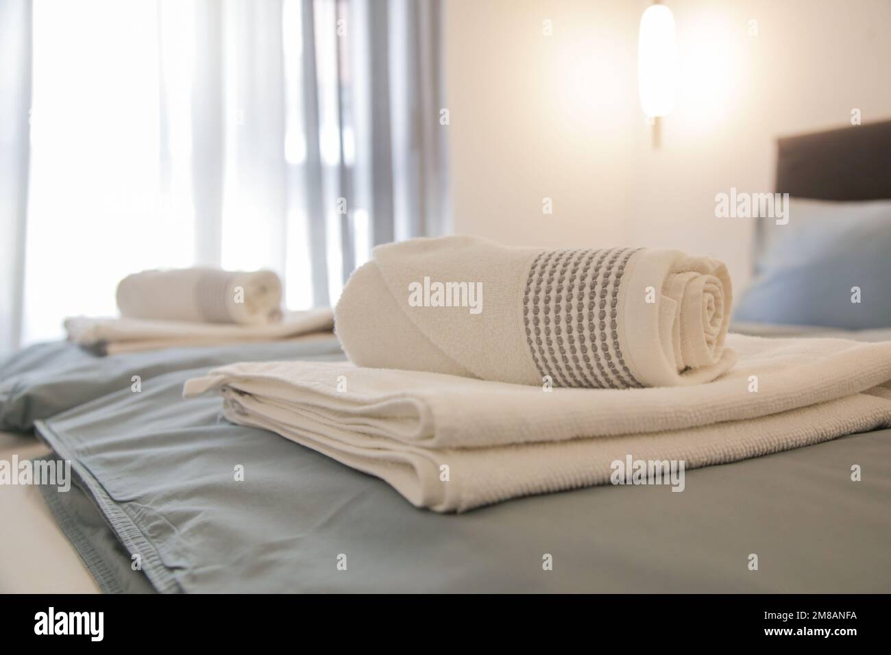 Clean towels on bed in modern interior bedroom Stock Photo Alamy