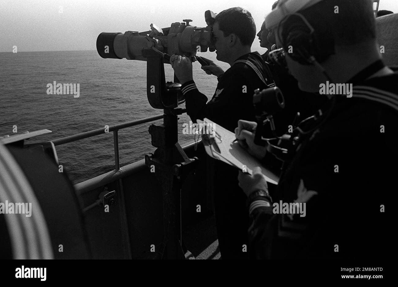 The intelligence team aboard the battleship USS MISSOURI (BB-63) checks information as they observe a Soviet Intelligence collector ship shadowing the MISSOURI. Country: Pacific Ocean (POC) Stock Photo