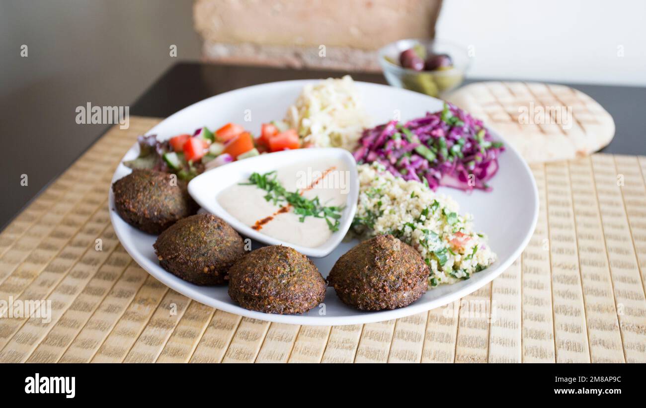 Falafel combo dish with vegetables. Faláfel or falafel is a chickpea or broad bean croquette. It
