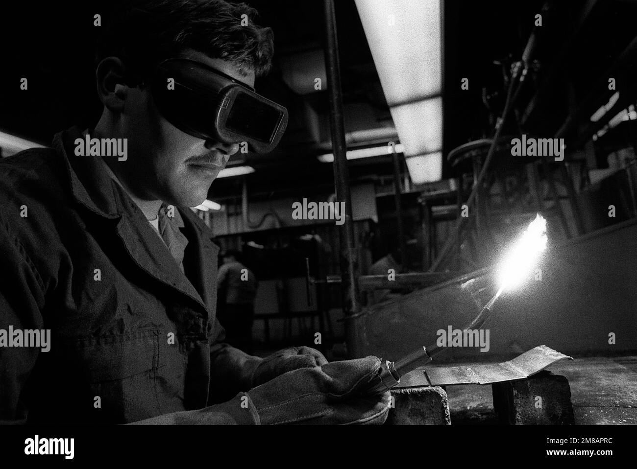A reservist adjusts the flame of an acetylene torch in a workshop at ...