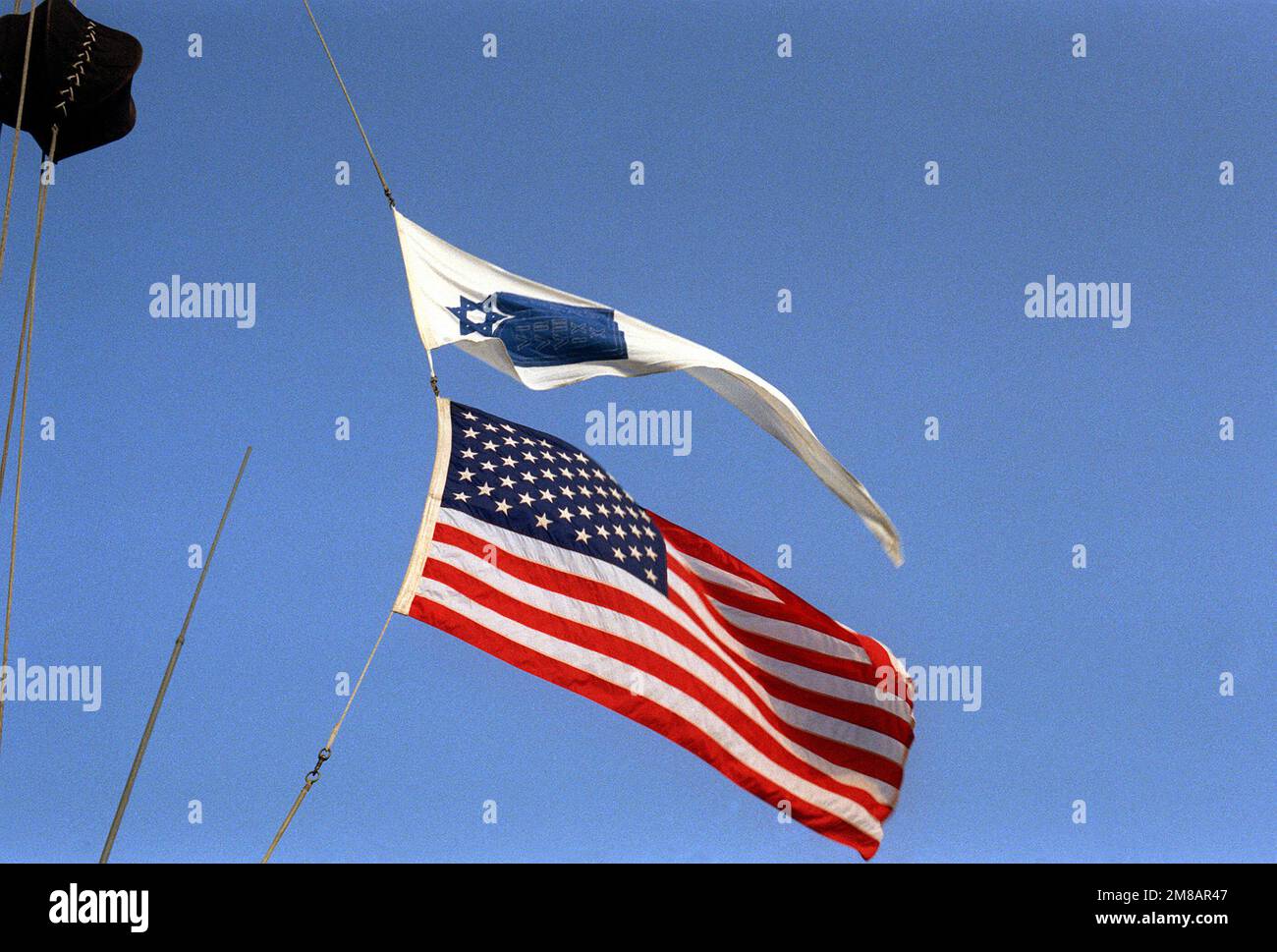 The pennant of the Jewish Chaplain Corps flies above the national ensign aboard the nuclear-powered aircraft carrier USS DWIGHT D. EISENHOWER (CVN-69) during Passover services. Base: Naval Air Station, Norfolk State: Virginia (VA) Country: United States Of America (USA) Stock Photo