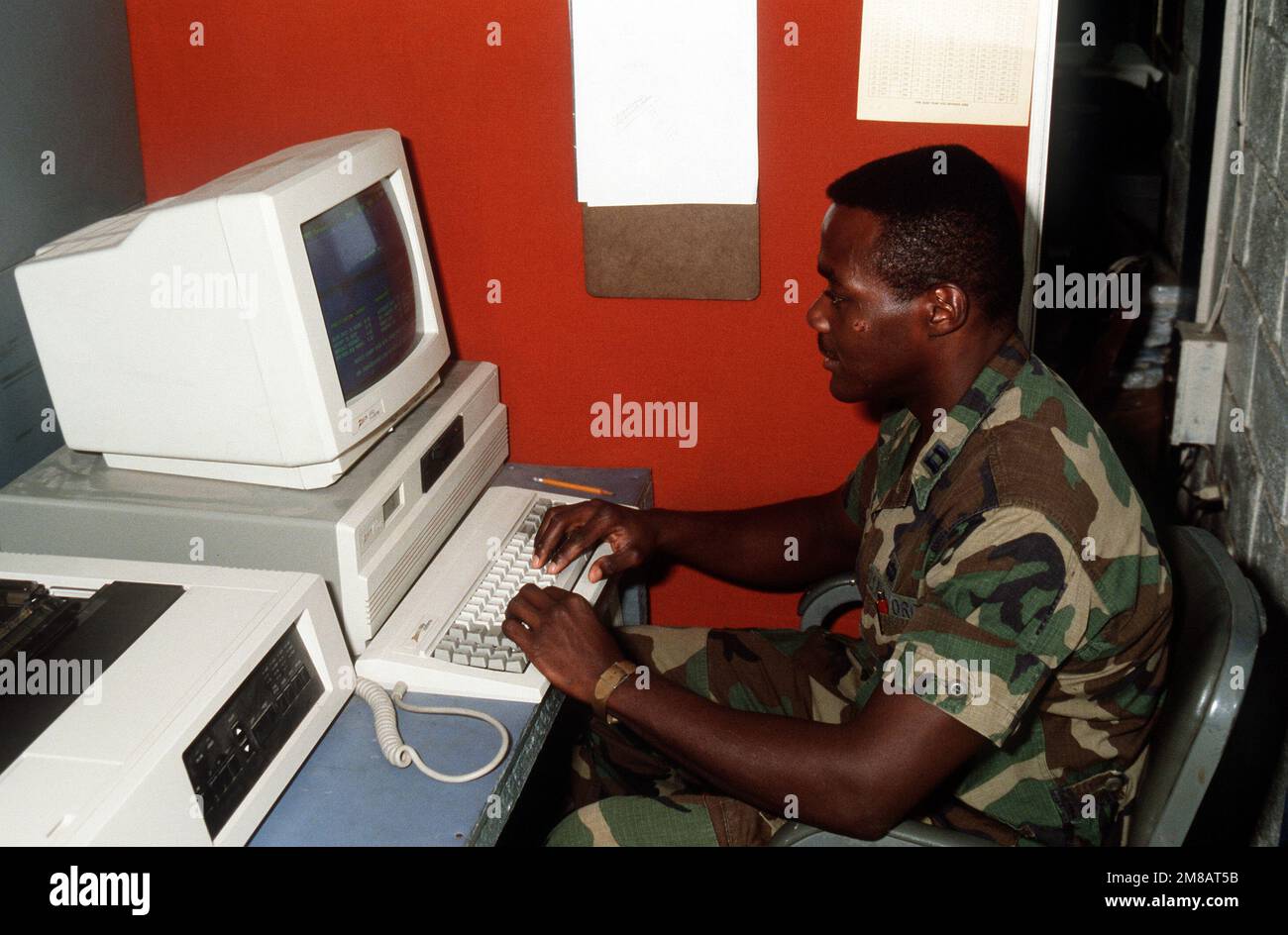 CPT Robert Thomas uses a word processor to put out the daily weather