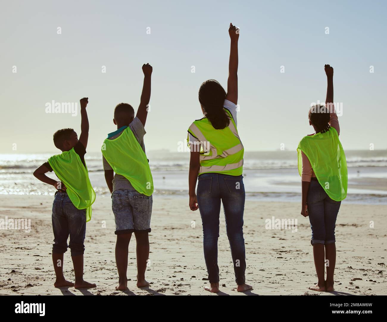 Back, activist and volunteer with friends on the beach for the conservation of the environment or sustainability. Charity, motivation and teamwork Stock Photo