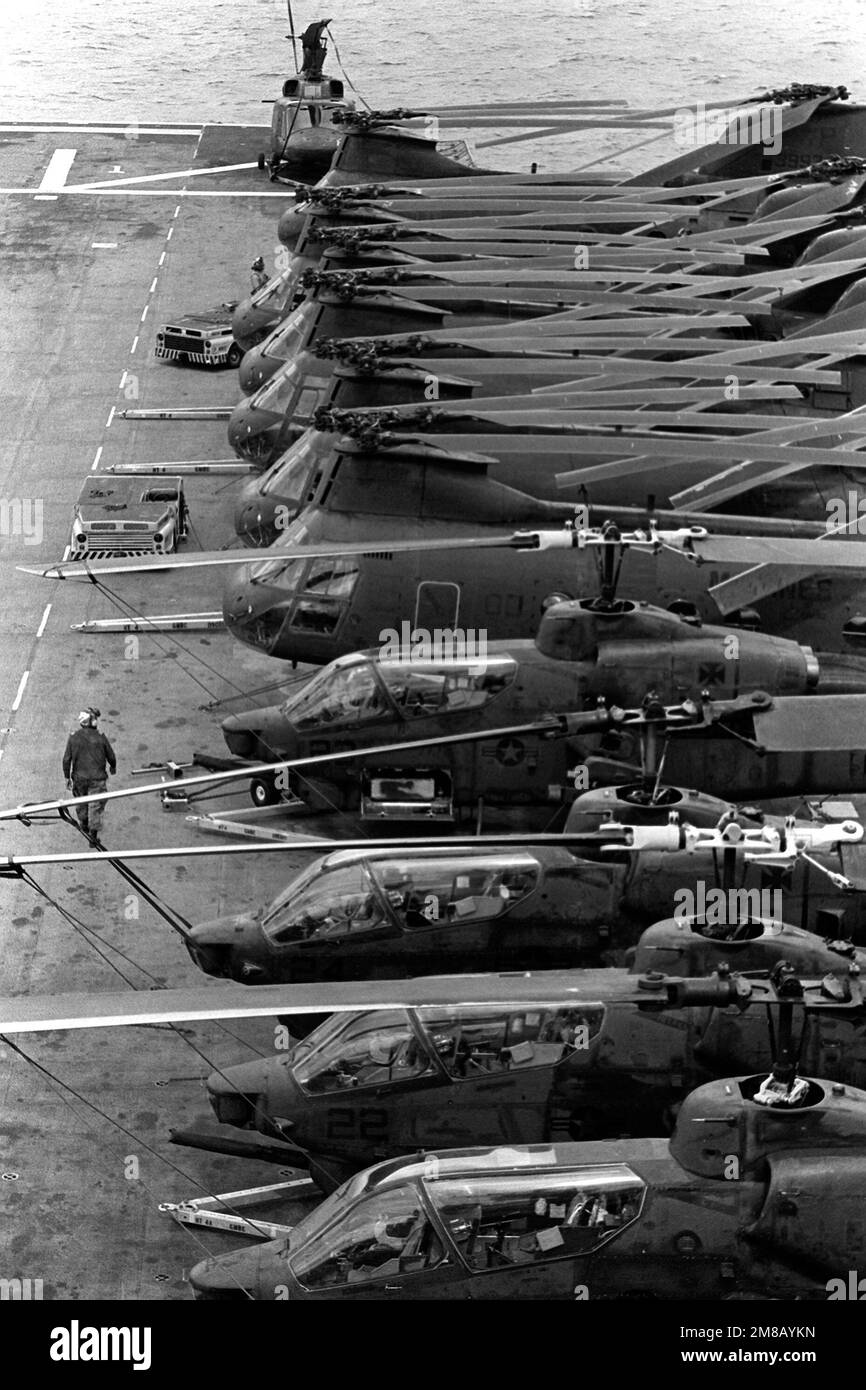 A view of AH-1 Sea Cobra and CH-46E Sea Knight helicopters parked on the flight deck of the amphibious assault ship USS BELLEAU WOOD (LHA-3). Country: Unknown Stock Photo