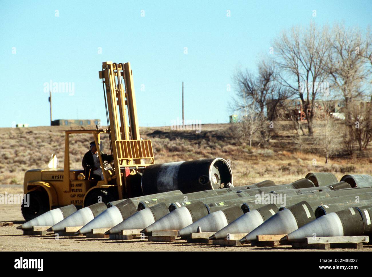 A depot employee uses a forklift to move a section of a Pershing II missile. Several missiles are being destroyed in the presence of Soviet inspectors in accordance with the Intermediate-Range Nuclear Forces (INF) Treaty. Base: Pueblo Army Depot Activity State: Colorado (CO) Country: United States Of America (USA) Stock Photo