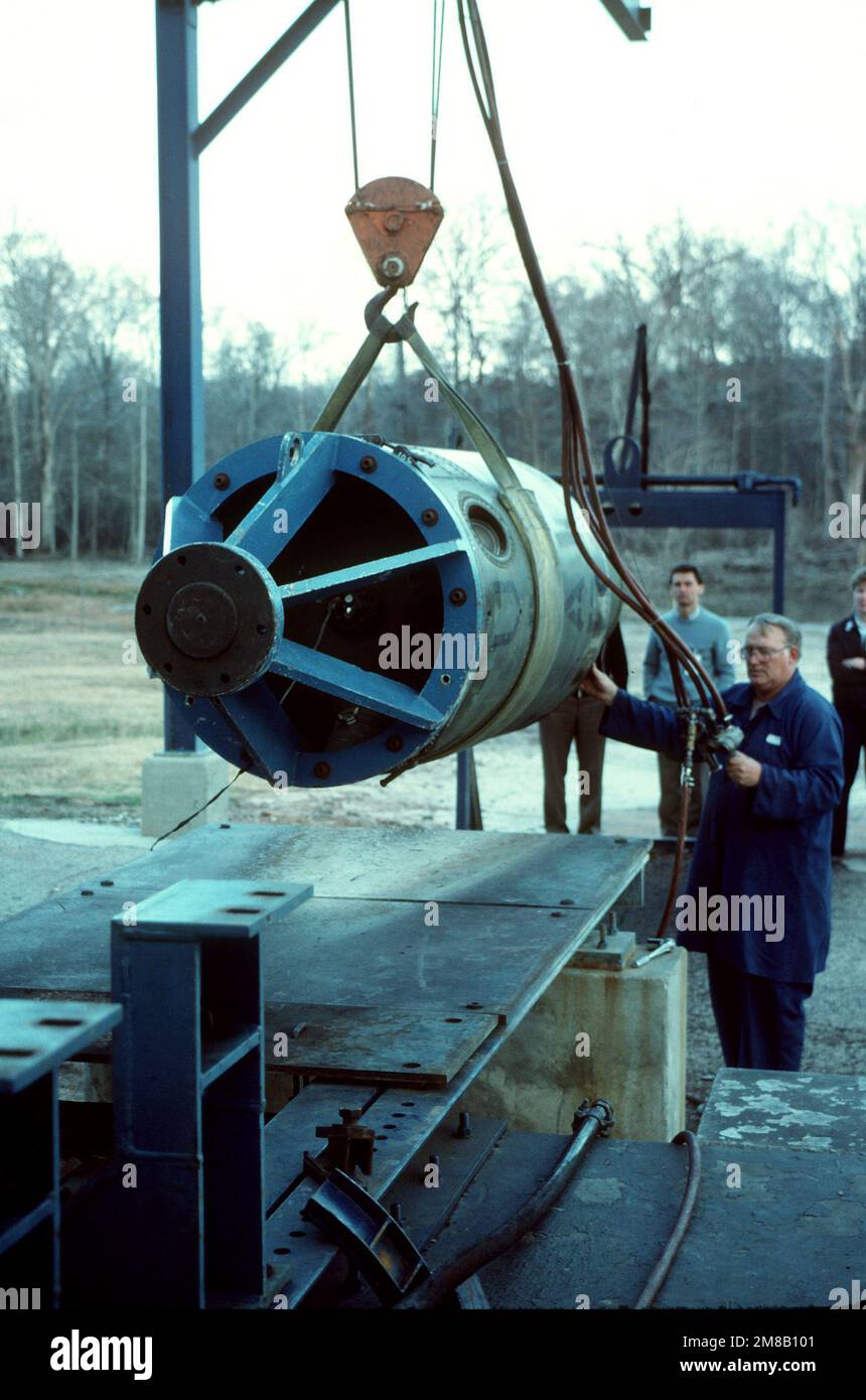 A plant employee steadies a propulsion stage from a Pershing 1A missile as it is lowered into place on a firing stand. Several missiles are being destroyed in the presence of Soviet inspectors in accordance with the Intermediate-Range Nuclear Forces (INF) Treaty. Base: Longhorn Army Ammunition Plant State: Texas (TX) Country: United States Of America (USA) Stock Photo