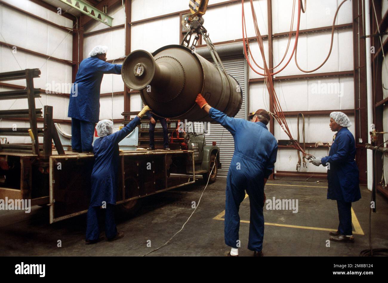 Plant employees steady a propulsion stage of a Pershing 1A missile as it is moved to the bed of a truck. Several missiles are being destroyed in the presence of Soviet inspectors in accordance with the Intermediate-Range Nuclear Forces (INF) Treaty. Base: Longhorn Army Ammunition Plant State: Texas (TX) Country: United States Of America (USA) Stock Photo