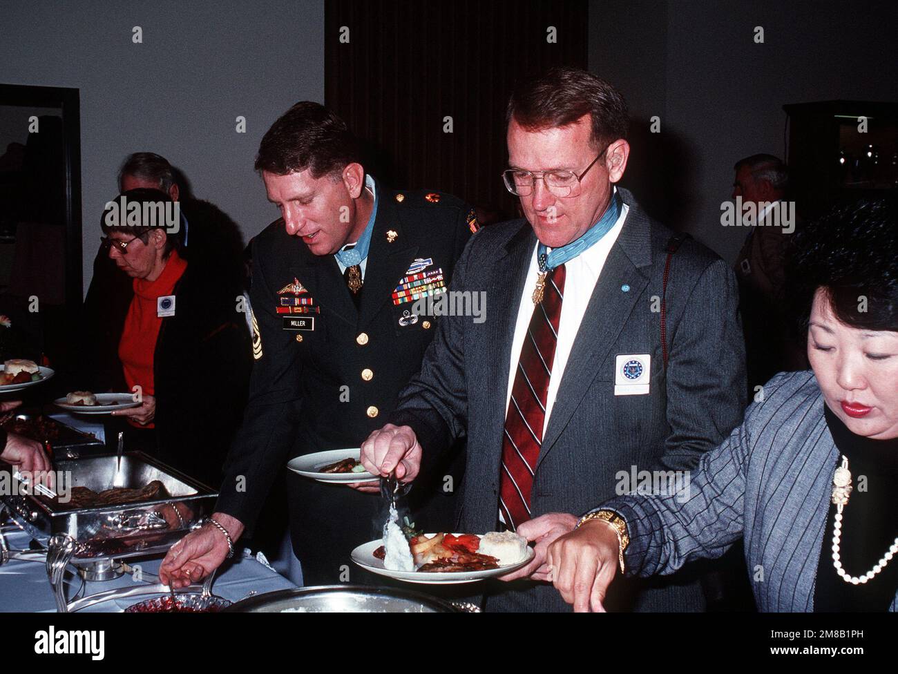 Medal of Honor recipients and guests pass through the buffet line during the Medal of Honor breakfast being held in conjunction with inaugural functions for George H.W. Bush, 41st president of the United States. Base: Washington State: District Of Columbia (DC) Country: United States Of America (USA) Stock Photo