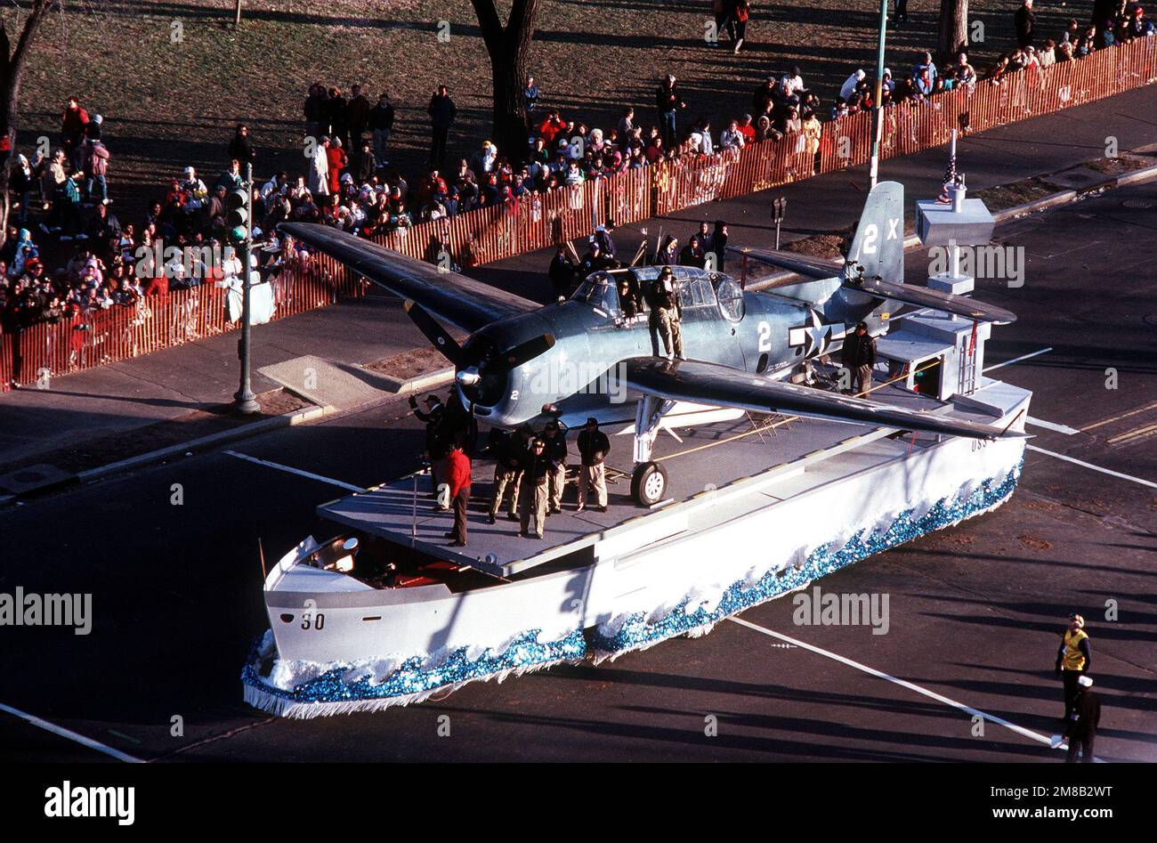 A float of an aircraft carrier with a TBF Avenger aircraft participates ...