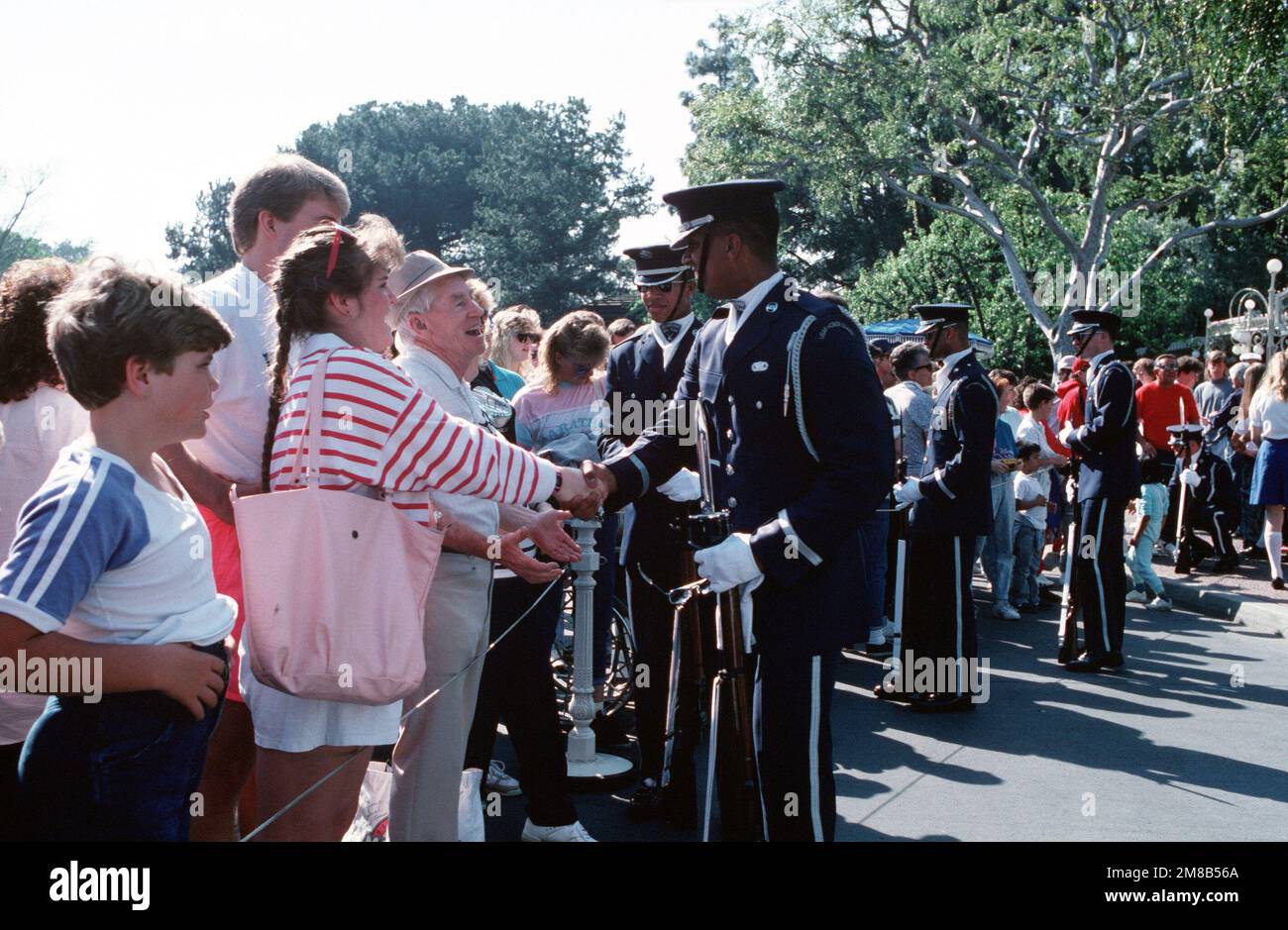 Members of the U.S. Air Force Honor Guard circulate with their audience at Disneyland following a memorial salute to the crew of the space shuttle Challenger. All seven members of the Challenger crew were killed in an explosion minutes after lift off on January 28, 1986. Base: Anaheim State: California (CA) Country: United States Of America (USA) Stock Photo