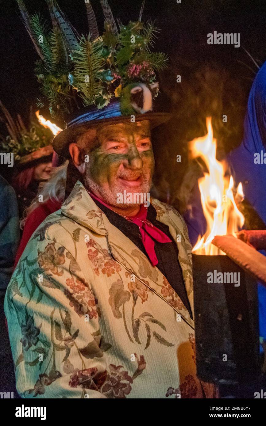 One of the Leominster Morris lighting torches before the annual Twelfth Night torchlight procession and wassail at Burton Court, Herefordshire, UK Stock Photo