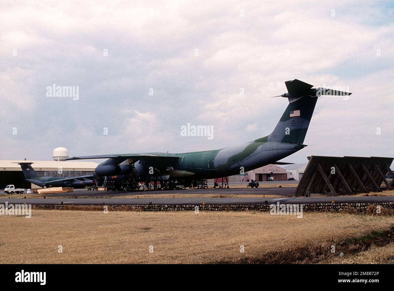 A 63rd Military Airlift Wing C-141B Starlifter aircraft sits up on jack ...