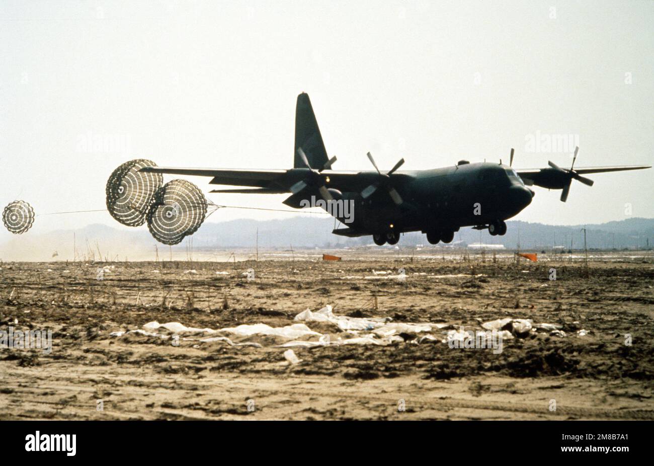 A 374th Tactical Airlift Wing (374th TAW) C130 Hercules aircraft makes a lowaltitude parachute