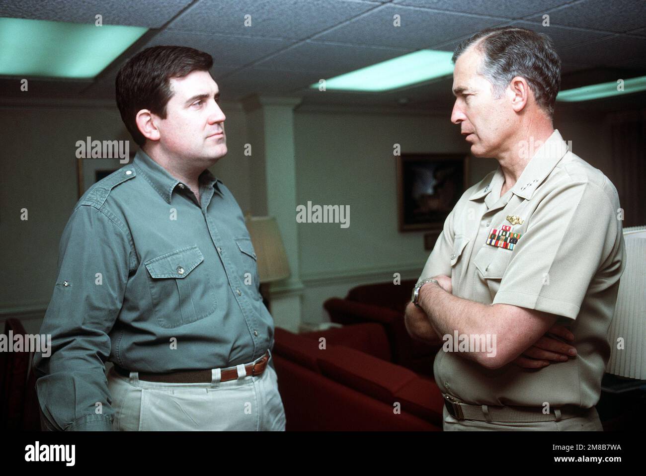 Secretary of the Navy William Ball converses with a flag officer during his visit to the USS THEODORE ROOSEVELT (CVN-71), the Navy's newest nuclear-pwoered aircraft carrier. Country: Mediterranean Sea (MED) Stock Photo