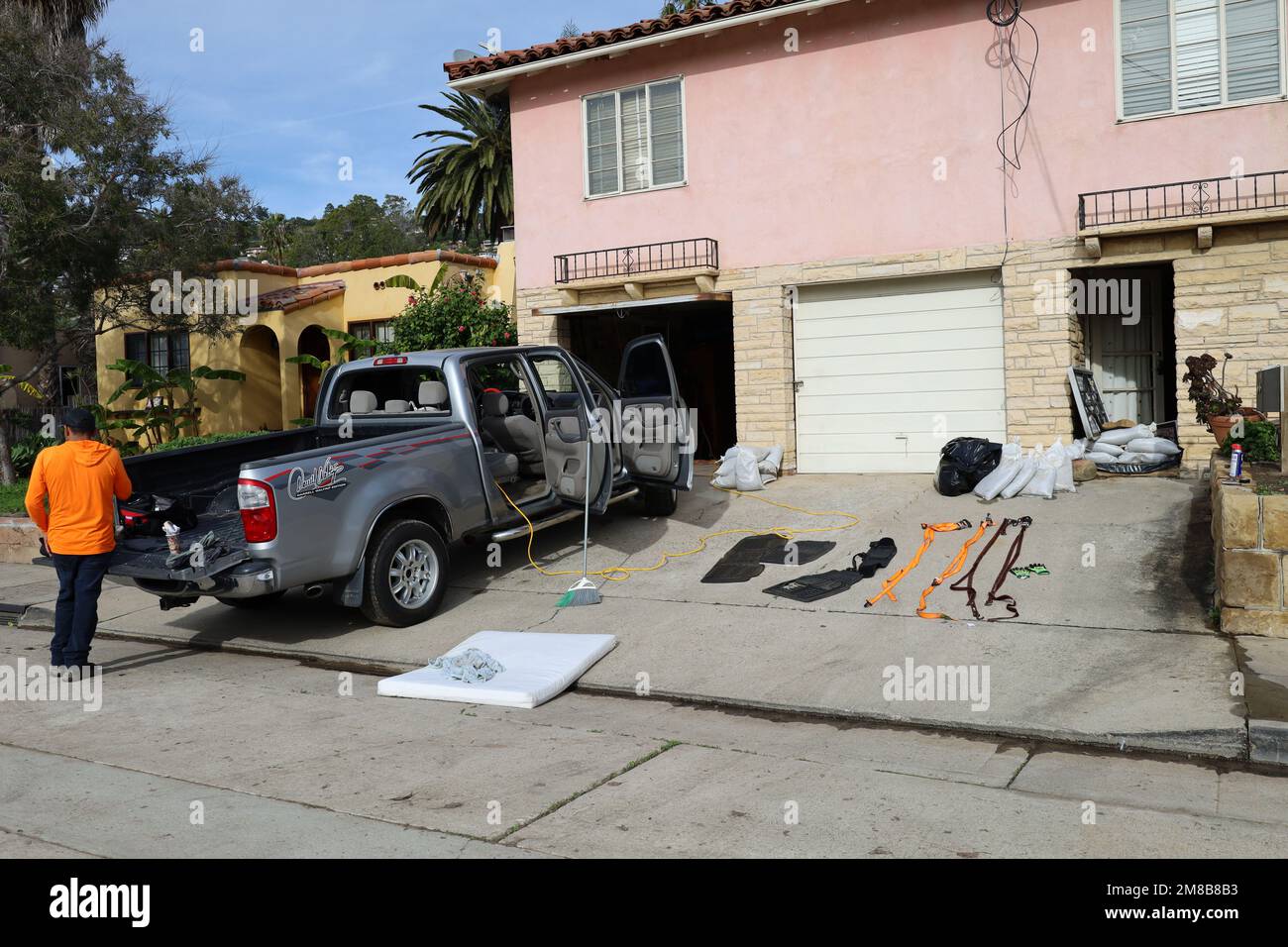 Santa Barbara, California, U.S.A. 12th Jan, 2023. Home owner Nelson Hernandez Polenco, who has been cleaning out his car and driveway, shows an image of cars floating in a sea of water in front of his house on Spring street. (Credit Image: © Amy Katz/ZUMA Press Wire) EDITORIAL USAGE ONLY! Not for Commercial USAGE! Stock Photo