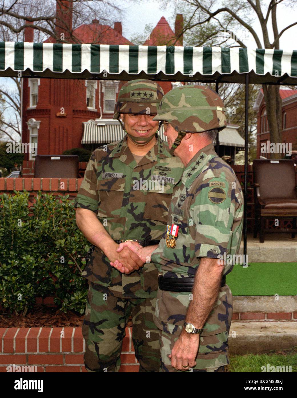 GEN. Colin L. Powell shakes hands with GEN. Joseph T. Palastra after Forces Command (FORSCOM) change of command in which GEN. Powell took command from GEN. Palastra. Base: Fort Mcpherson State: Georgia (GA) Country: United States Of America (USA) Stock Photo