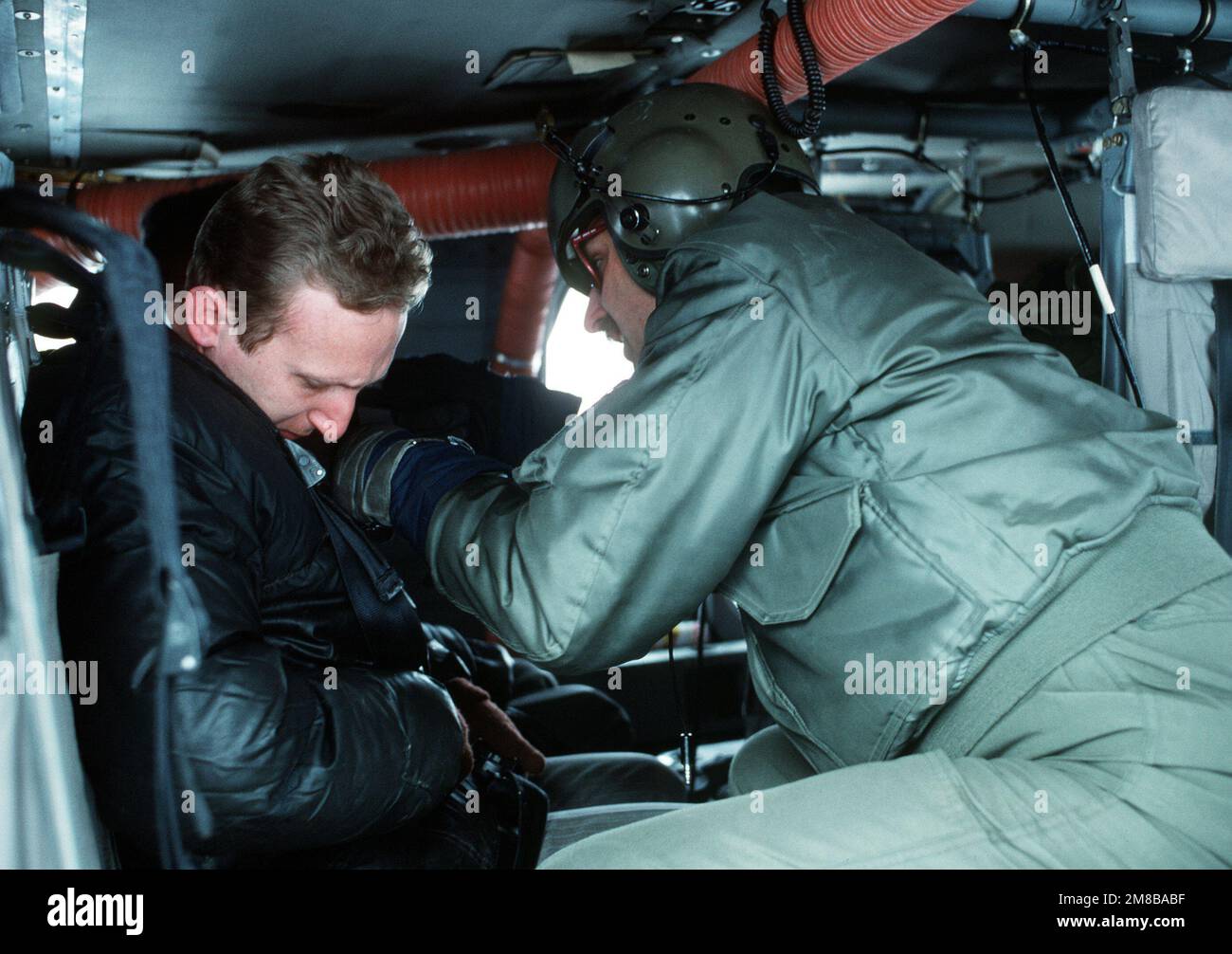 An Alaska Air National Guardsman straps Alexander Kendr, a Soviet ...