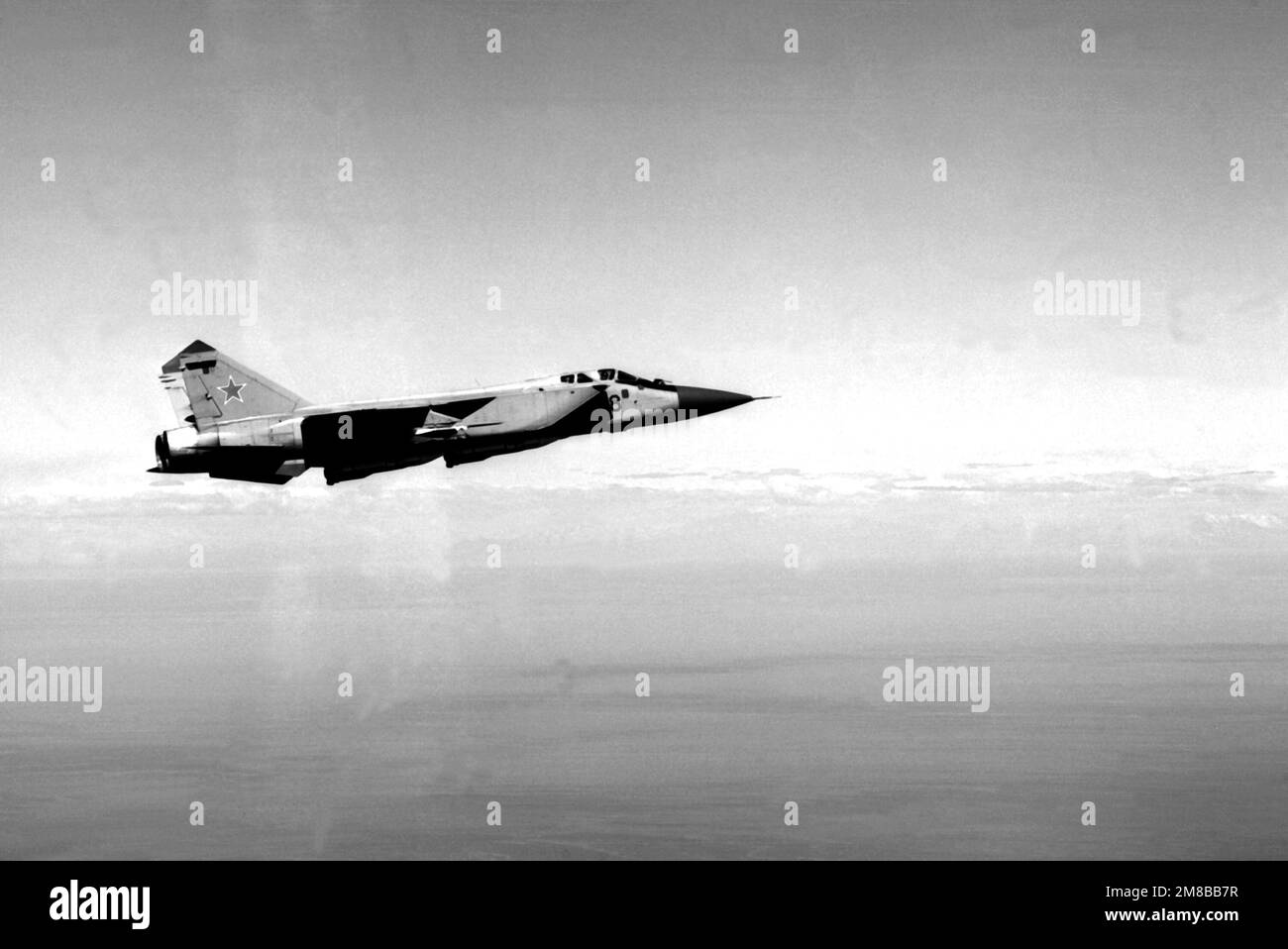 A right side view of a Soviet MiG-31 Foxhound fighter aircraft in-flight. Country: Unknown Stock Photo