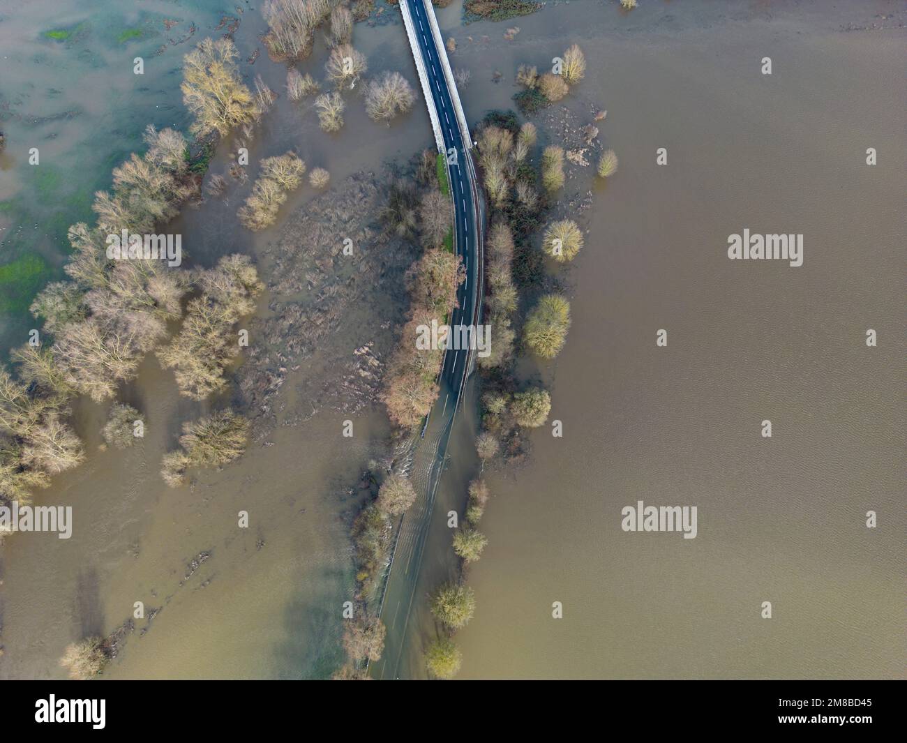 Heuchelheim, Germany. 13th Jan, 2023. A country road near Heuchelheim in Hesse is flooded after days of rainfall (aerial photo taken with a drone). Further rainfall could cause more rivers and streams to burst their banks. Credit: Boris Roessler/dpa/Alamy Live News Stock Photo