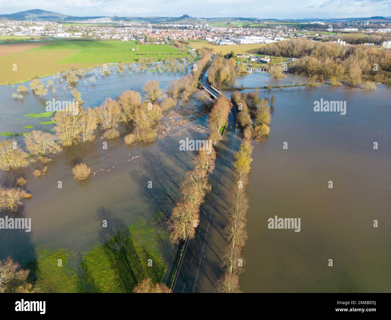 Heuchelheim, Germany. 13th Jan, 2023. A country road near Heuchelheim in Hesse is flooded after days of rainfall (aerial photo taken with a drone). With further rainfall, more rivers and streams could burst their banks. Credit: Boris Roessler/dpa/Alamy Live News Stock Photo