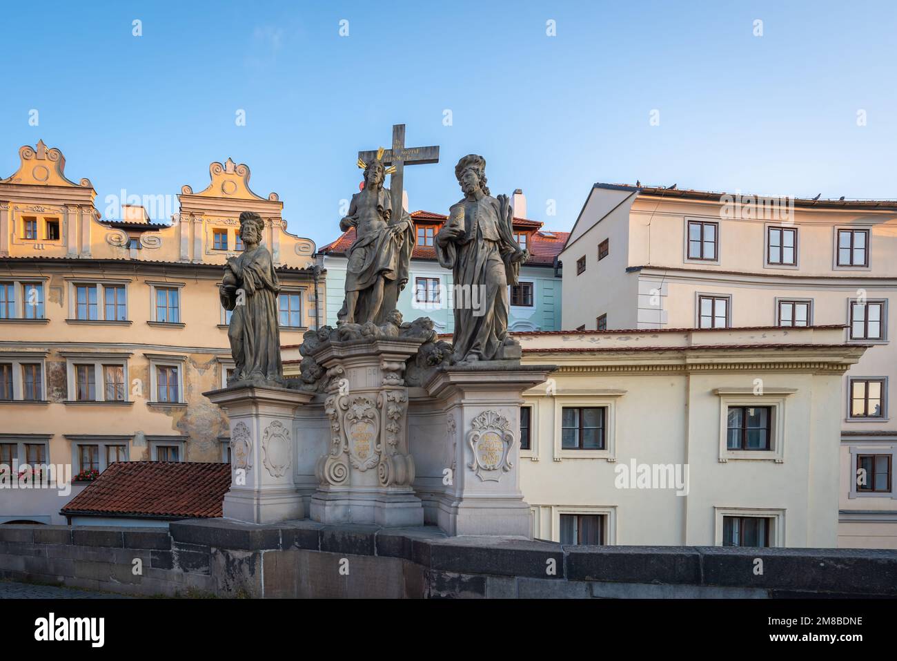 Statue of Holy Savior with Cosmas and Damian at Charles Bridge - Prague, Czech Republic Stock Photo