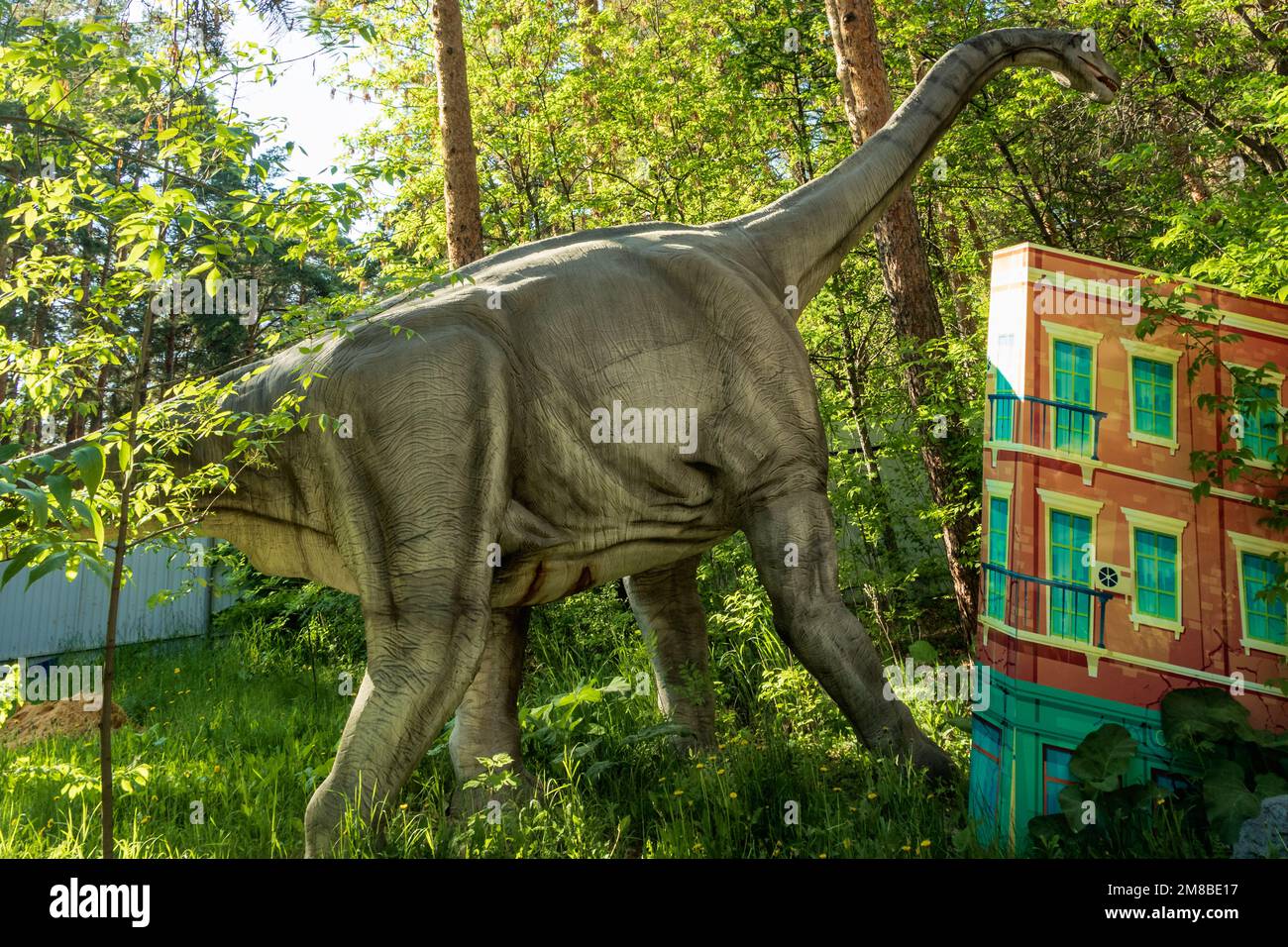 Chelyabinsk, Russia - June 01, 2022. A dinosaur figure stands in a city ...