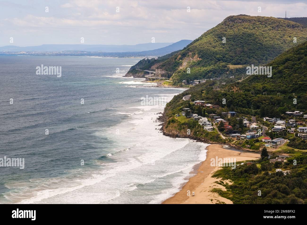 Stanwell Park Beach in New South Wales, Australia with the Sea Cliff bridge in the distance Stock Photo