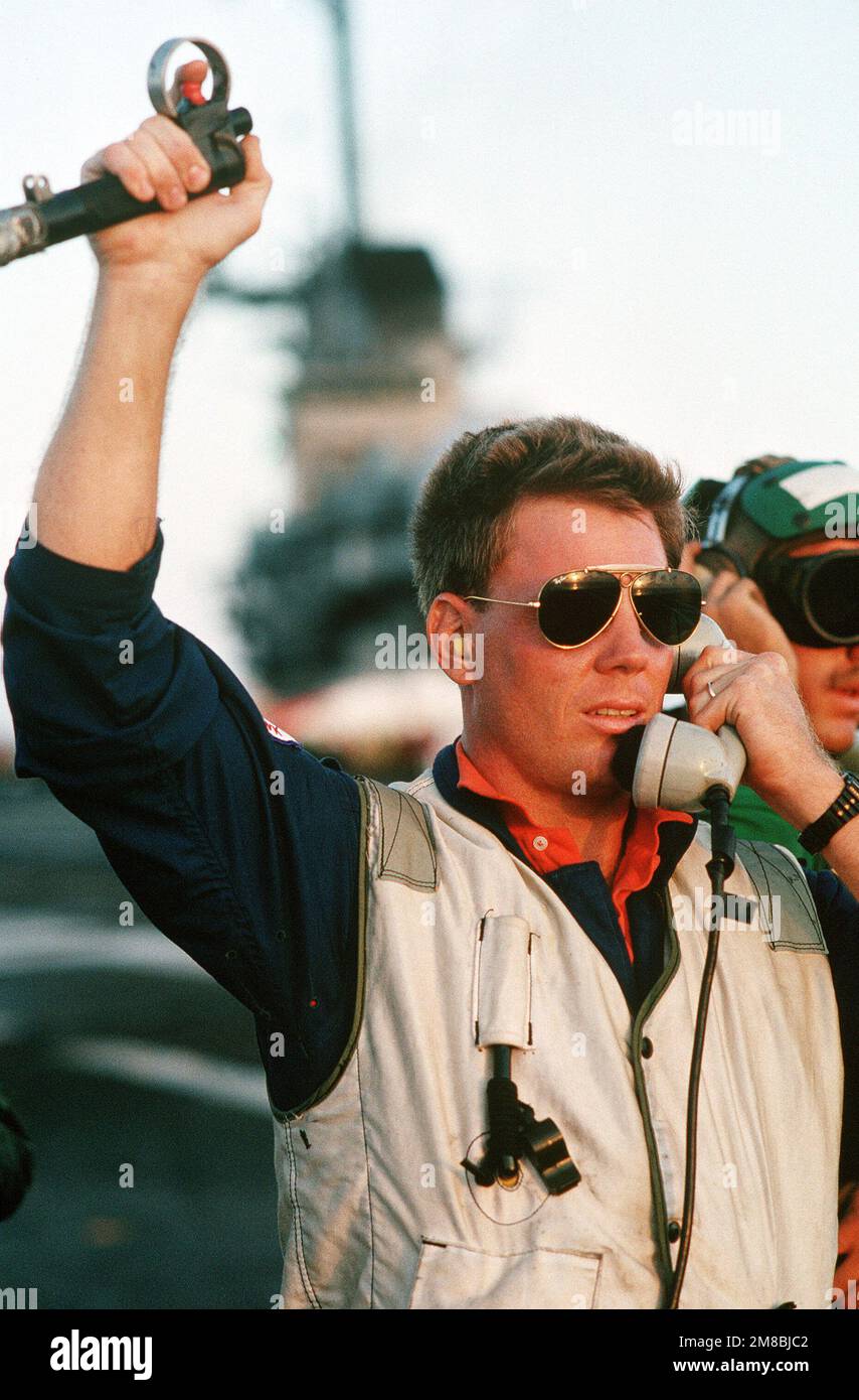 A landing signal officer (LSO) on the flight deck of the auxiliary