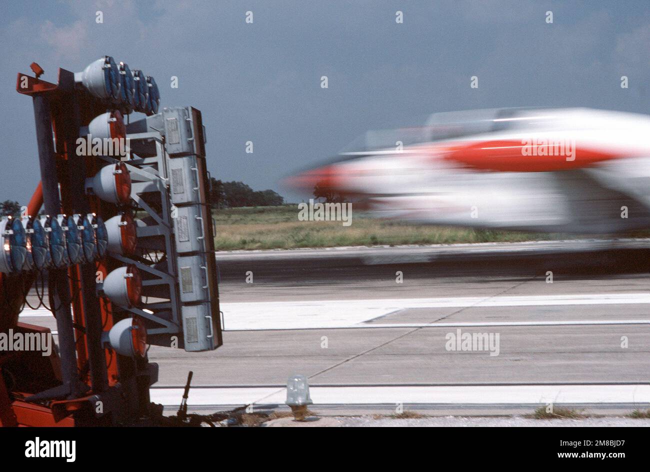 A T2C Buckeye aircraft flashes past a fresnel lens optical landing