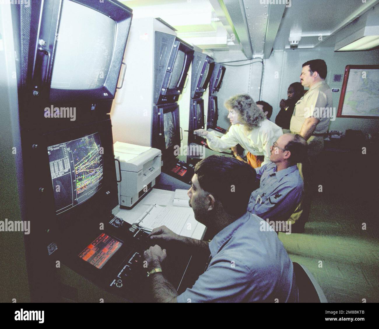 Military and civilian personnel cooperate in the development of a