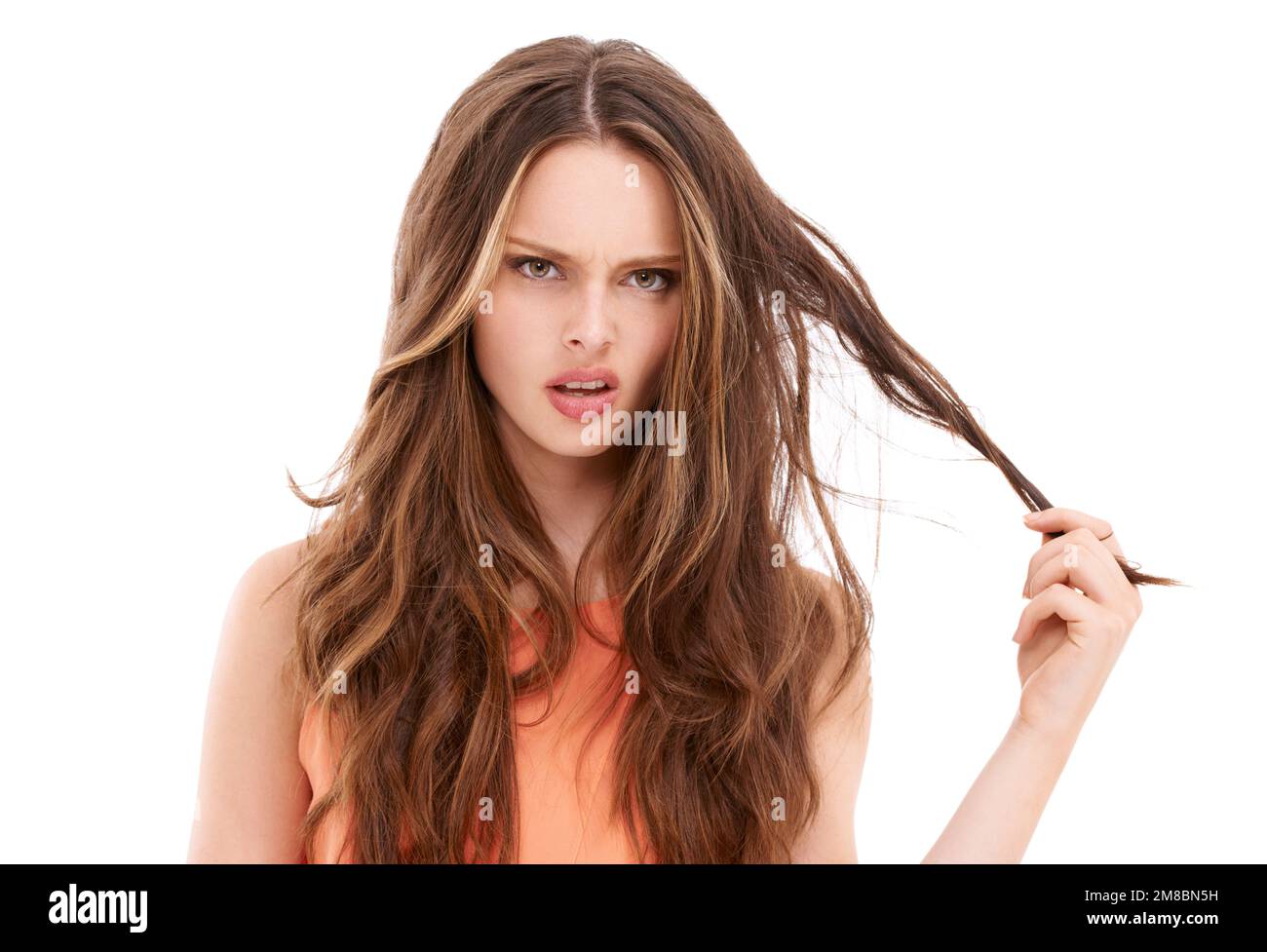 Woman portrait, stress or angry with messy hairstyle on isolated white background for split ends, keratin treatment or grooming. Confused beauty model Stock Photo