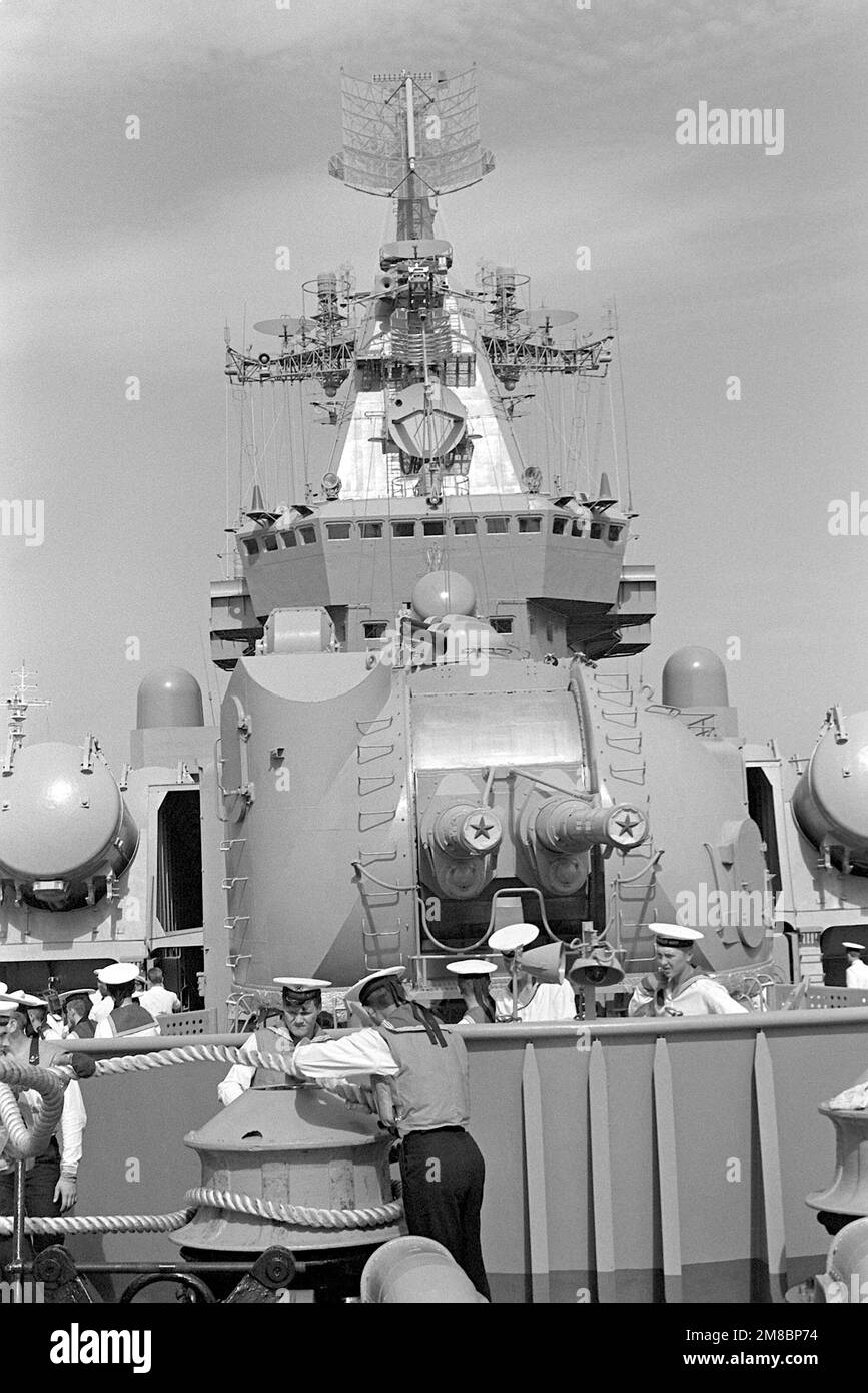 Soviet sailors handle a line on the bow of the Soviet Slava class ...