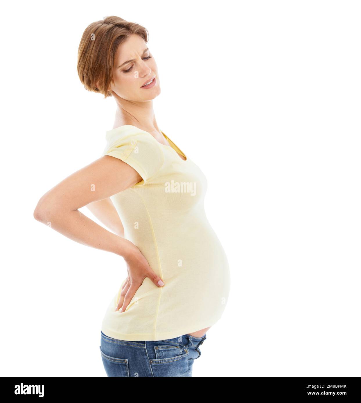 Woman, pregnant and back pain in studio by white background with