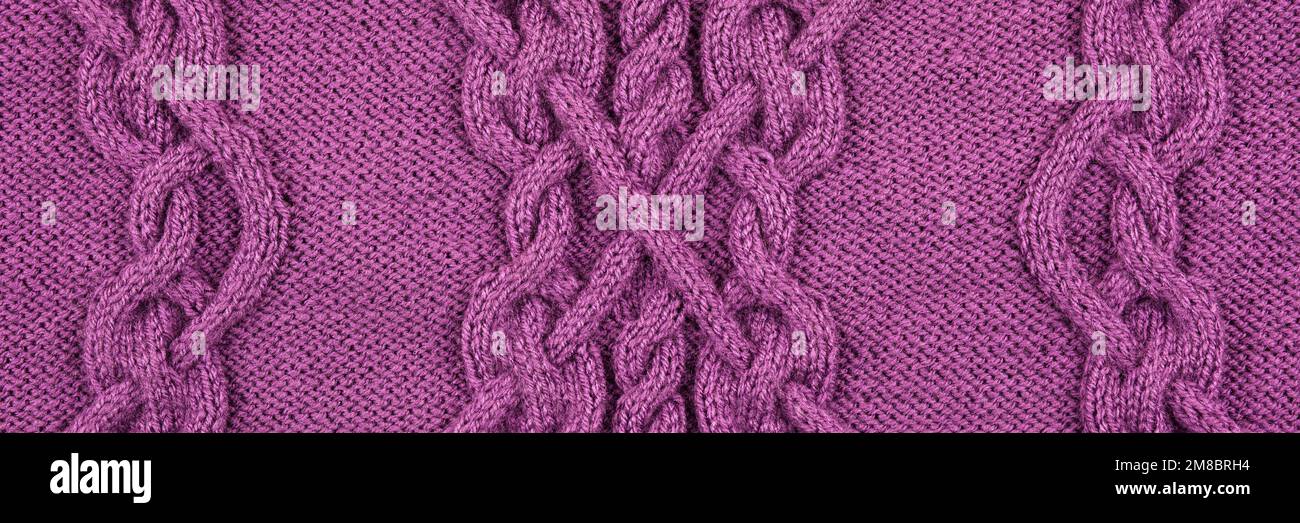 Knitted lilac background. Large knitted fabric with a pattern. Close-up of a knitted blanket. Horizontal ornament. Banner Stock Photo