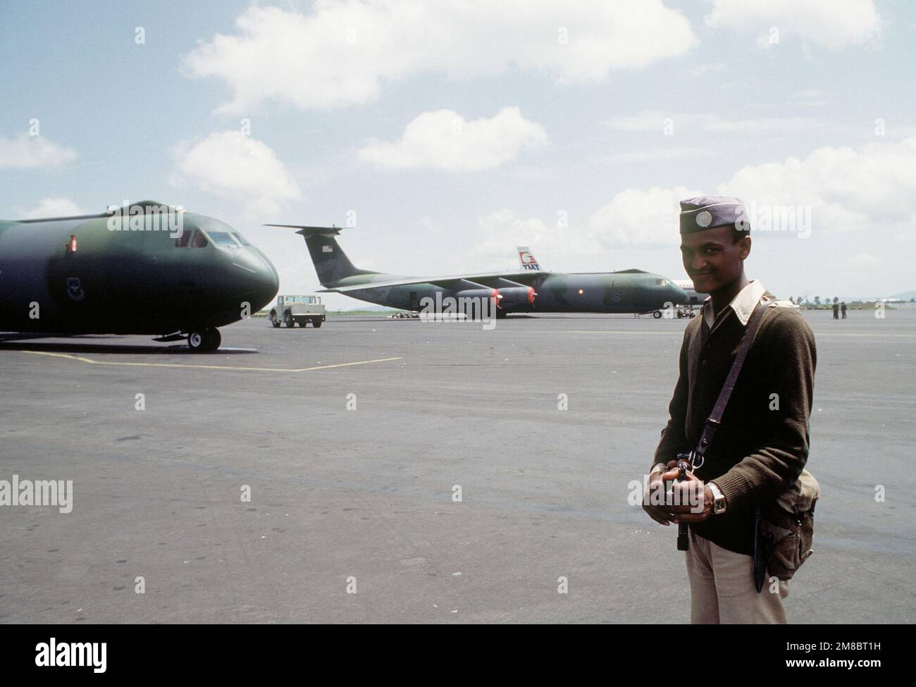 A security guard maintains his post near C-141B Starlifter aircraft on ...