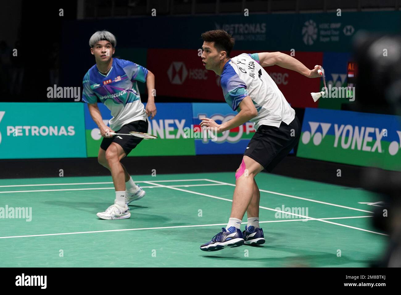Malaysias Ong Yew Sin, right and Teo Ee Yi plays a shot against Indonesias Fajar Alfian and Muhammad Rian Ardianto during their mens doubles quarterfinals match at the Malaysia Open badminton tournament