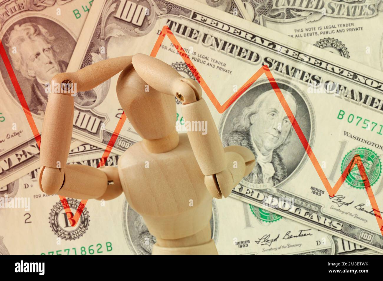 Wooden mannequin with hands on head in despair and descending line on